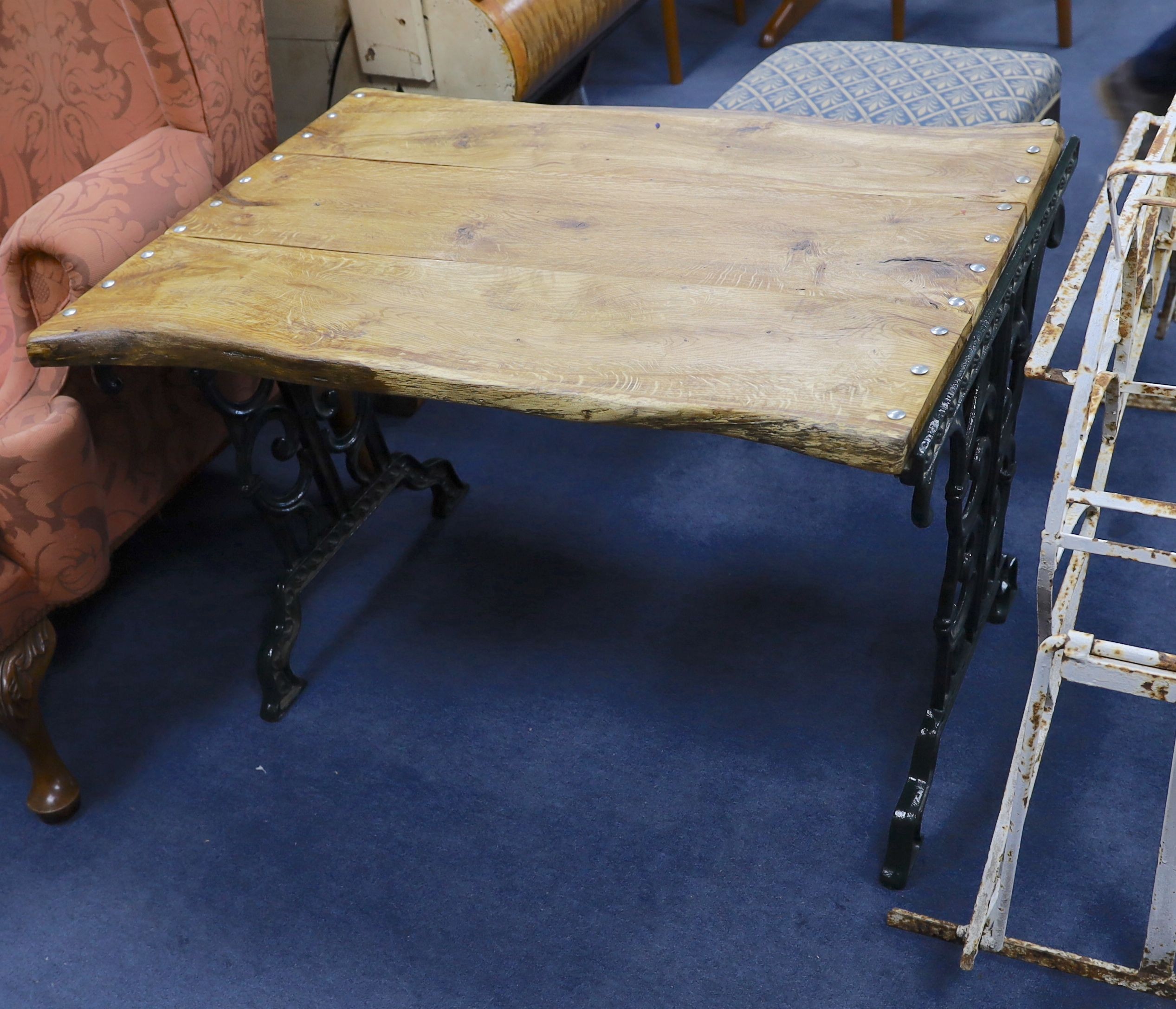 A Victorian style painted cast iron garden table with waney edge top, width 102cm, depth 70cm, height 68cm